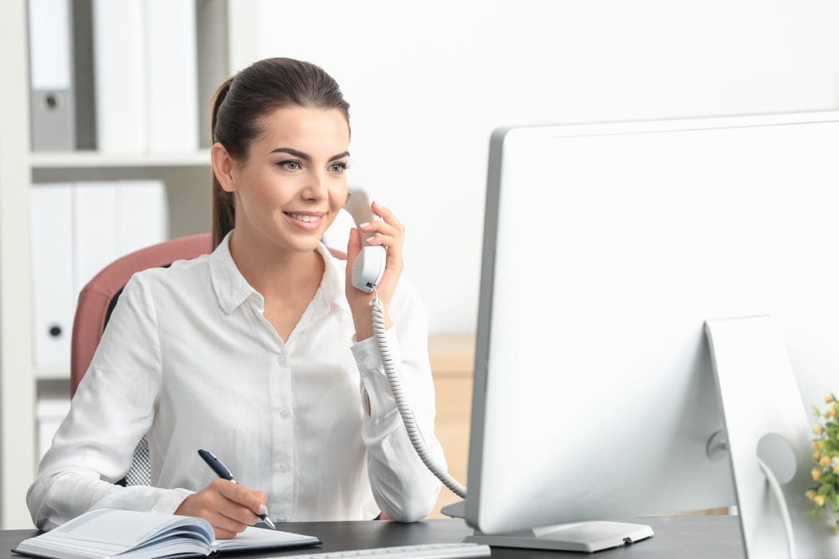 A BaseResidences support specialist helping a customer by phone